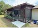 Screened in porch with outdoor seating and roses at 486 S Us Highway 1, Oak Hill, FL 32759