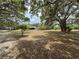 Expansive property with trees, lawn and home in the distance at 486 S Us Highway 1, Oak Hill, FL 32759