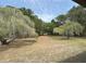 A view of the property with large trees at 486 S Us Highway 1, Oak Hill, FL 32759