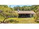 Charming home featuring a cozy, covered patio; perfect for outdoor relaxation at 486 S Us Highway 1, Oak Hill, FL 32759