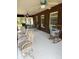 Spacious screened porch with ceiling fans, chairs, a table and windows offering pleasant views at 486 S Us Highway 1, Oak Hill, FL 32759