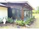 Screened porch featuring a brown frame, garden view, and comfortable seating arrangement at 486 S Us Highway 1, Oak Hill, FL 32759