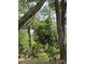 Image shows tropical landscaping in a wooded yard at 486 S Us Highway 1, Oak Hill, FL 32759