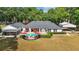 Aerial view of the backyard pool, patio, and home exterior surrounded by green grass at 5865 Ross Creek Rd, Lakeland, FL 33810