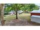 Expansive backyard with a large tree, shed, and views of the home's rear exterior at 5865 Ross Creek Rd, Lakeland, FL 33810