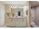 Bathroom with double sink vanity, large mirror, and a tiled walk-in shower at 5865 Ross Creek Rd, Lakeland, FL 33810
