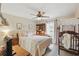 Cozy bedroom with a ceiling fan, a bed with patterned bedding, and a desk area at 5865 Ross Creek Rd, Lakeland, FL 33810