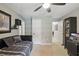 Neutral toned bedroom with a modern futon and built-in shelves for storage and decoration at 5865 Ross Creek Rd, Lakeland, FL 33810
