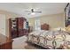 Bedroom with dark wood furniture and a patterned quilt at 5865 Ross Creek Rd, Lakeland, FL 33810