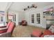 Relaxing covered patio with ceiling fans, brick flooring, TV, and comfortable furniture at 5865 Ross Creek Rd, Lakeland, FL 33810