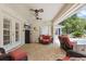 Inviting covered patio with ceiling fans, brick flooring, and comfortable seating at 5865 Ross Creek Rd, Lakeland, FL 33810