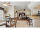 Open-concept dining area with a view to the living room and stainless steel appliances in the kitchen at 5865 Ross Creek Rd, Lakeland, FL 33810