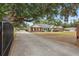 Charming brick home with a long driveway and a well-maintained front yard at 5865 Ross Creek Rd, Lakeland, FL 33810