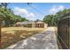Gated brick home with a long driveway and a well-maintained front yard at 5865 Ross Creek Rd, Lakeland, FL 33810