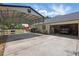 Large driveway leading to a garage with carport and ample parking space at 5865 Ross Creek Rd, Lakeland, FL 33810