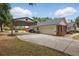 Spacious garage with a carport and ample parking on an expansive driveway at 5865 Ross Creek Rd, Lakeland, FL 33810