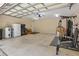 An oversized garage provides storage with exercise and work out equipment, shelving, and lighting at 5865 Ross Creek Rd, Lakeland, FL 33810