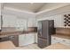Well-lit kitchen with stainless steel appliances, white cabinets, wine rack and modern fixtures at 5865 Ross Creek Rd, Lakeland, FL 33810
