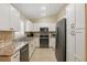 Kitchen features stainless steel appliances, white cabinets and tile backsplash at 5865 Ross Creek Rd, Lakeland, FL 33810