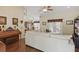 Bright living room featuring a piano, ceiling fan, wood floors and view of the dining room at 5865 Ross Creek Rd, Lakeland, FL 33810