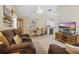 Cozy living room featuring a large sectional sofa, TV, and open access to the dining area and kitchen at 5865 Ross Creek Rd, Lakeland, FL 33810