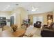 Open concept living room features vaulted ceilings and door to outdoor area at 5865 Ross Creek Rd, Lakeland, FL 33810
