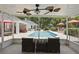 Enclosed patio area overlooking sparkling pool with manicured landscaping at 5865 Ross Creek Rd, Lakeland, FL 33810