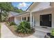 Inviting front porch with black shutters and lush landscaping at 5865 Ross Creek Rd, Lakeland, FL 33810