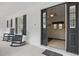 Covered porch with rocking chairs and a view into a living area, creating an inviting entry at 5865 Ross Creek Rd, Lakeland, FL 33810