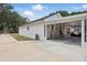 Home's rear exterior features a carport, additional seating area, and backyard at 5865 Ross Creek Rd, Lakeland, FL 33810