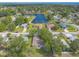 A lovely aerial view of the neighborhood, featuring a serene lake and well-maintained homes with lush landscaping at 613 Clairmont Ln, South Daytona, FL 32119