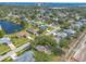 An aerial neighborhood view showcasing a serene lake, mature trees, and inviting streets at 613 Clairmont Ln, South Daytona, FL 32119