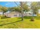 Beautiful backyard with lush green grass and mature trees, perfect for outdoor living and relaxation at 613 Clairmont Ln, South Daytona, FL 32119