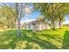Well-maintained backyard with a trellis and mature trees at 613 Clairmont Ln, South Daytona, FL 32119