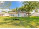 Well-maintained backyard featuring a swing and a large grassy area at 613 Clairmont Ln, South Daytona, FL 32119