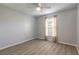 Comfortable bedroom featuring light wood laminate flooring and a ceiling fan at 613 Clairmont Ln, South Daytona, FL 32119