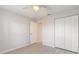 Cozy bedroom featuring gray walls, updated floors, ceiling fan and large closet at 613 Clairmont Ln, South Daytona, FL 32119