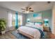 This staged bedroom features bright turquoise accent colors and natural light at 613 Clairmont Ln, South Daytona, FL 32119