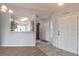 Foyer view showcasing the kitchen, white front door, and neutral decor at 613 Clairmont Ln, South Daytona, FL 32119