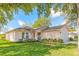Charming single story home with a well-manicured lawn and attractive landscaping at 613 Clairmont Ln, South Daytona, FL 32119