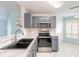 Well-equipped kitchen with stainless steel appliances, a modern sink, and bright white countertops at 613 Clairmont Ln, South Daytona, FL 32119