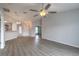 Open living space featuring wood-look flooring and a modern ceiling fan for comfortable living at 613 Clairmont Ln, South Daytona, FL 32119