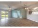 Spacious living area with wood look floors, view of the kitchen, and access to the backyard at 613 Clairmont Ln, South Daytona, FL 32119