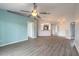 Open concept living area with wood look flooring and views of the kitchen at 613 Clairmont Ln, South Daytona, FL 32119