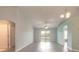 Spacious living room with wood-look floors, ceiling fan, and sliding glass doors at 613 Clairmont Ln, South Daytona, FL 32119
