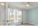 This home office features natural light, neutral walls, and wood flooring at 613 Clairmont Ln, South Daytona, FL 32119