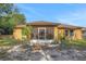 The backyard is turfed and shows the back exterior of the home with a screened in porch at 881 Westline Ave, Deltona, FL 32725
