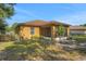 Exterior view of home featuring a backyard with a screened in porch area and manicured lawn at 881 Westline Ave, Deltona, FL 32725