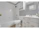 Bathroom with white tile, a shower-tub combo, and a sink with decorative leaf accents at 881 Westline Ave, Deltona, FL 32725