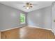 Bedroom with wood-look flooring and a window with a ceiling fan at 881 Westline Ave, Deltona, FL 32725